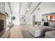 Open living room features wood floors, natural light, and seamless flow to kitchen at 8499 101St Ave, Seminole, FL 33777