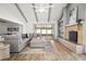 Spacious living room boasts vaulted ceiling, fireplace, wood floors, and access to screened patio at 8499 101St Ave, Seminole, FL 33777