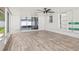Spacious tiled porch with ceiling fan, sliding glass doors, and street view from the window in this bright space at 8499 101St Ave, Seminole, FL 33777