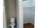 Bathroom with toilet, and access to a closet with shelving at 904 Grand Canyon Dr, Valrico, FL 33594