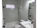 Bright bathroom with quartz countertop and white tiling, along with black hardware at 904 Grand Canyon Dr, Valrico, FL 33594