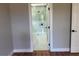 Bathroom doorway to a glass shower with white and grey tiling and black fixtures at 904 Grand Canyon Dr, Valrico, FL 33594