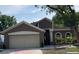 Charming home featuring a two-car garage, arched windows, and meticulous landscaping at 904 Grand Canyon Dr, Valrico, FL 33594