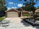 Charming single-Gathering home featuring a well-maintained lawn and a two-car garage at 904 Grand Canyon Dr, Valrico, FL 33594