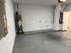 Clean two-car garage featuring new epoxy floor and water heater at 904 Grand Canyon Dr, Valrico, FL 33594