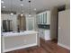 Modern kitchen featuring an island with a quartz countertop, stainless steel appliances, and wood-look floors at 904 Grand Canyon Dr, Valrico, FL 33594