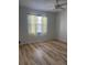 Bedroom with ceiling fan, light-colored walls, and wood look flooring at 13829 Mission Oaks Blvd, Seminole, FL 33776
