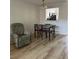 Open dining area with wood-look floors, adjacent to the kitchen and living space at 13829 Mission Oaks Blvd, Seminole, FL 33776