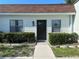 Inviting home exterior featuring a well-maintained front yard and charming facade at 13829 Mission Oaks Blvd, Seminole, FL 33776