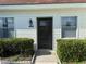 Close-up of the home's entrance, showcasing the well-lit doorway at 13829 Mission Oaks Blvd, Seminole, FL 33776