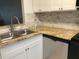 Updated kitchen features stainless steel sink, granite countertops, white cabinets, and tiled backsplash at 13829 Mission Oaks Blvd, Seminole, FL 33776