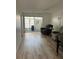 Bright living room with wood-look floors and comfortable seating, leading to a screened lanai at 13829 Mission Oaks Blvd, Seminole, FL 33776