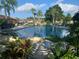 Serene swimming pool surrounded by lush tropical landscaping, creating a peaceful oasis at 13829 Mission Oaks Blvd, Seminole, FL 33776