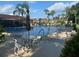 Relaxing poolside area with ample seating and shade for leisure and enjoyment near the water at 13829 Mission Oaks Blvd, Seminole, FL 33776