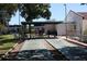 Outdoor shuffleboard courts with seating and shade for leisure and recreation on a sunny day at 13829 Mission Oaks Blvd, Seminole, FL 33776
