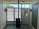 Cozy sunroom featuring large window, white walls, and a decorative rug for a relaxing retreat at 13829 Mission Oaks Blvd, Seminole, FL 33776