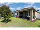 Backyard with a covered patio, green lawn, and white fence providing a private outdoor space at 11711 Winterset Cove Dr, Riverview, FL 33579