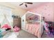 Cozy bedroom designed for play, featuring a small play tent and decorative wall accents at 11711 Winterset Cove Dr, Riverview, FL 33579