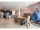 Open-concept dining area with a stylish light fixture and seating for six at 11711 Winterset Cove Dr, Riverview, FL 33579