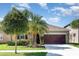 Inviting home with well-maintained landscaping, mature trees, and a two-car garage at 11711 Winterset Cove Dr, Riverview, FL 33579
