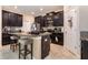 Modern kitchen features granite counters, dark cabinets, and stainless steel appliances at 11711 Winterset Cove Dr, Riverview, FL 33579