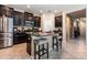 Stylish kitchen features granite counters, dark cabinets, and stainless steel appliances at 11711 Winterset Cove Dr, Riverview, FL 33579