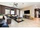 Comfortable living room with tiled floors, modern entertainment center, and natural light at 11711 Winterset Cove Dr, Riverview, FL 33579