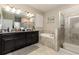 Luxurious main bathroom with soaking tub, walk-in shower, and dual sink vanity at 11711 Winterset Cove Dr, Riverview, FL 33579