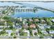 Stunning aerial view of waterfront homes, featuring lush landscaping and bridge views at 120 Crestwood Ln, Largo, FL 33770