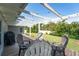 A covered wooden back porch features outdoor seating with a table to enjoy the well-maintained backyard at 120 Crestwood Ln, Largo, FL 33770