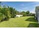 Extensive backyard with a well-maintained lawn and lush landscaping, perfect for outdoor activities at 120 Crestwood Ln, Largo, FL 33770
