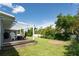 Expansive backyard with lush green grass, a wooden deck, and fire pit, ideal for entertaining at 120 Crestwood Ln, Largo, FL 33770