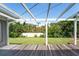 Backyard view from under a covered patio with beautiful plants and a lush green lawn at 120 Crestwood Ln, Largo, FL 33770