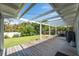 Spacious deck with an outdoor grill and dining set overlooking a lush green yard with a brick fire pit at 120 Crestwood Ln, Largo, FL 33770
