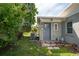 Exterior view featuring the side of the home with an AC unit, gas tank, and back entry door at 120 Crestwood Ln, Largo, FL 33770