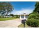 Charming single-story home featuring a large yard, concrete driveway, and a two-car garage with modern blue doors at 120 Crestwood Ln, Largo, FL 33770