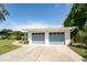 The home has a two-car garage, a well-manicured lawn, and updated landscaping at 120 Crestwood Ln, Largo, FL 33770