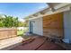 There is an outdoor, uncovered wooden deck with a hot tub next to the side door of the home at 120 Crestwood Ln, Largo, FL 33770