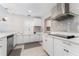 Bright kitchen with white cabinetry, stainless steel appliances, and sleek countertops, perfect for cooking and entertaining at 120 Crestwood Ln, Largo, FL 33770