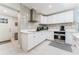 Modern kitchen featuring white cabinets, stainless steel appliances, and a sleek range hood at 120 Crestwood Ln, Largo, FL 33770