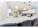 Modern kitchen with white cabinets, stainless steel appliances, a large island, and stylish pendant lighting at 120 Crestwood Ln, Largo, FL 33770