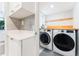 A bright laundry room features newer appliances, a butcher block counter, and extra storage at 120 Crestwood Ln, Largo, FL 33770