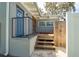 The side yard of the home has a wooden deck with a side entrance, as well as space for a hot tub at 120 Crestwood Ln, Largo, FL 33770
