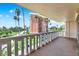 This balcony has white railings and offers a view of city buildings, street traffic, and palm trees at 1200 N Shore Ne Dr # 404, St Petersburg, FL 33701