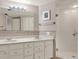 This bathroom features a double sink vanity, a framed mirror, and a glass shower at 1200 N Shore Ne Dr # 404, St Petersburg, FL 33701