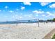 Scenic view of beach volleyball court with blue nets and clear water under a bright sky at 1200 N Shore Ne Dr # 404, St Petersburg, FL 33701