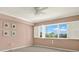 Bright bedroom with large windows and plantation shutters, complemented by light walls and gray carpet at 1200 N Shore Ne Dr # 404, St Petersburg, FL 33701