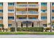 Low angle of the building's facade featuring stone accents, balconies, and the Shore Crest sign at 1200 N Shore Ne Dr # 404, St Petersburg, FL 33701