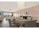 Bright dining room featuring a chandelier, seating for four, and sliding doors to a balcony at 1200 N Shore Ne Dr # 404, St Petersburg, FL 33701