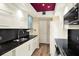 Modern kitchen with black countertops, stainless steel appliances, and plenty of cabinet space at 1200 N Shore Ne Dr # 404, St Petersburg, FL 33701